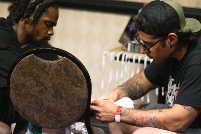 Fighter receiving hand wraps before a match